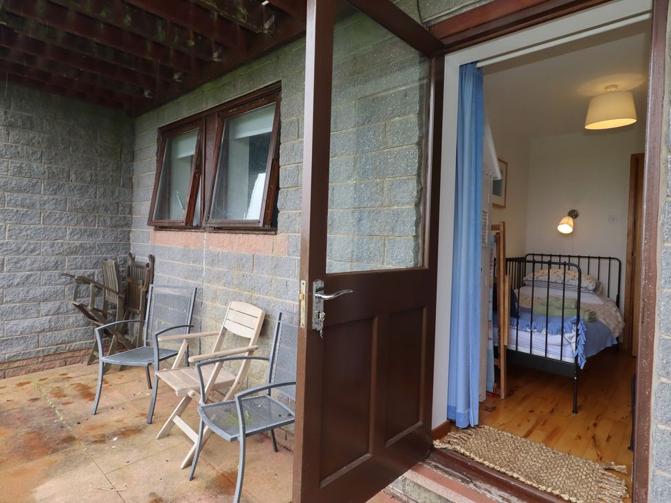 A porch with chairs and a bedroom visible at Links View Embleton