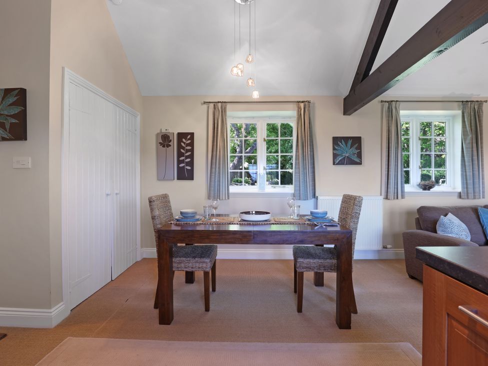 A dining room with a table and chairs at Plumtree Cottage in Alnmouth