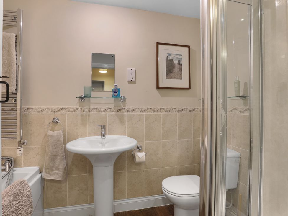 A bathroom with a sink and shower at Plumtree Cottage in Alnmouth