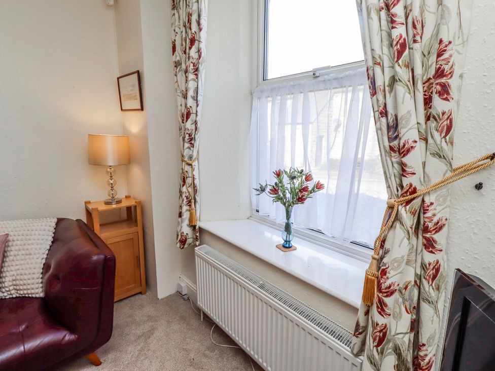 A living room with a sofa and lamp at Hardys House in Alnwick