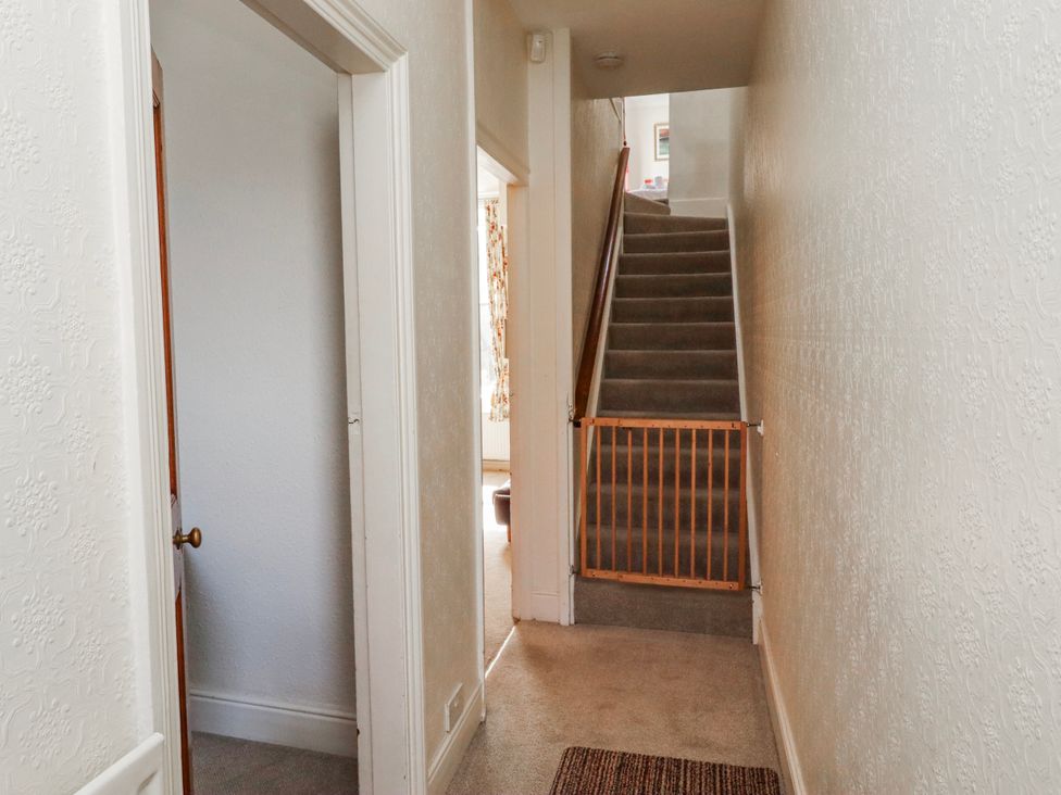 A hallway with a staircase and a gate at Hardys House in Alnwick