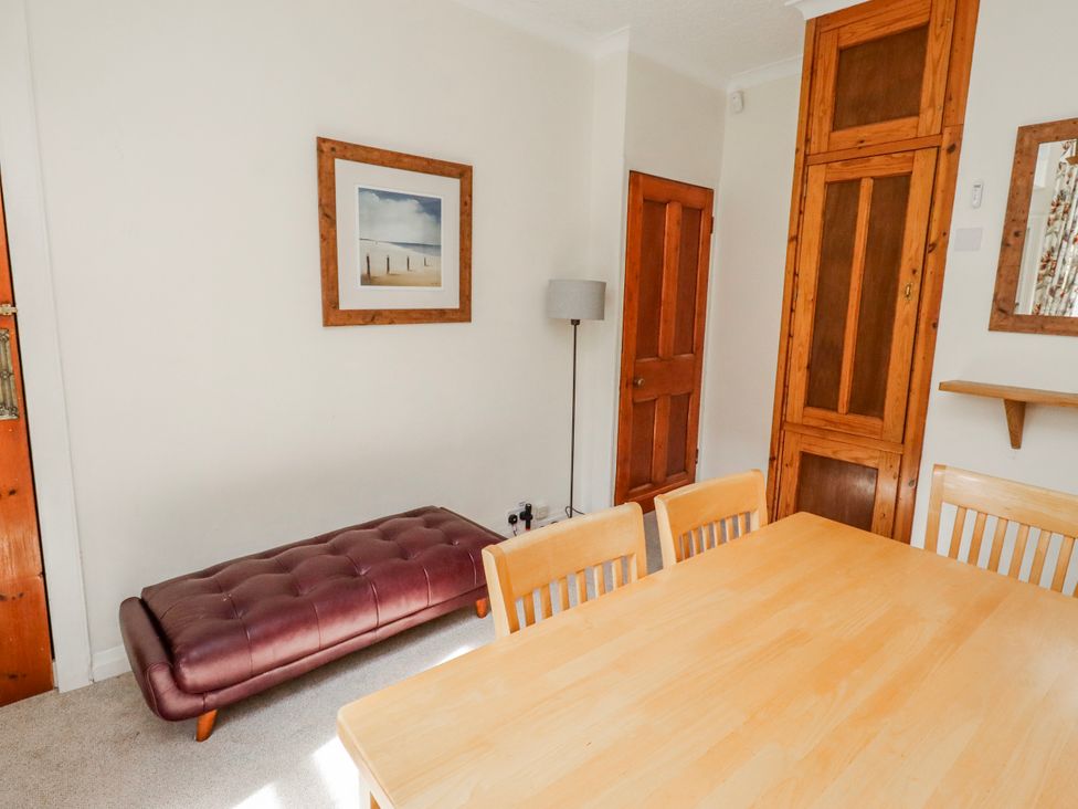 A dining room with a table, chairs, and a bench at Hardys House in Alnwick