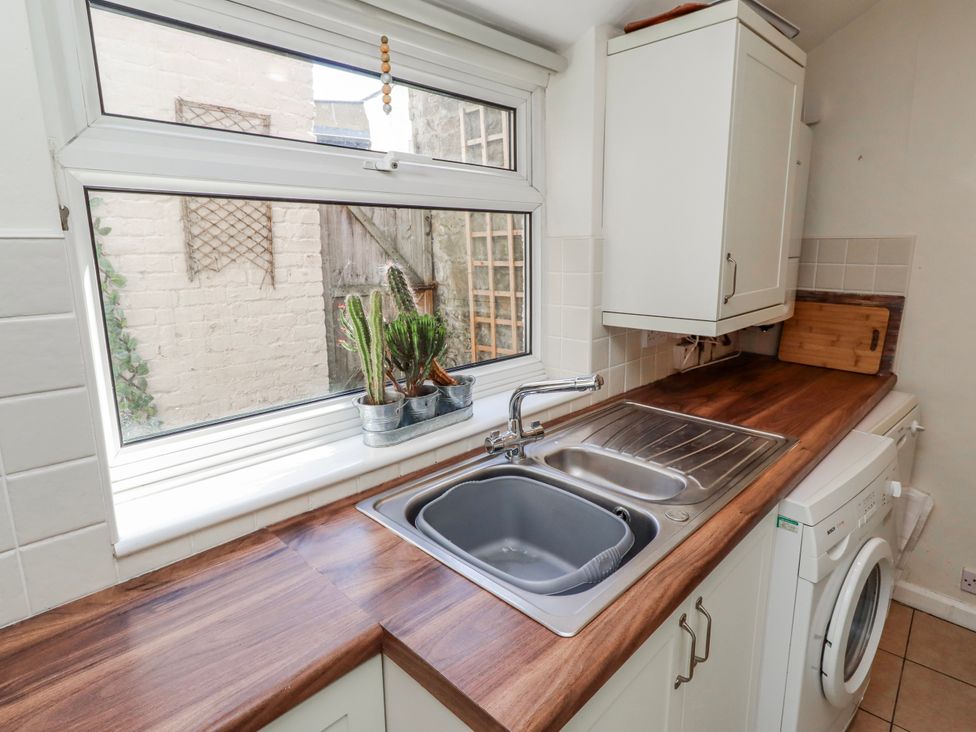 A kitchen with a sink and a washing machine at Hardys House in Alnwick