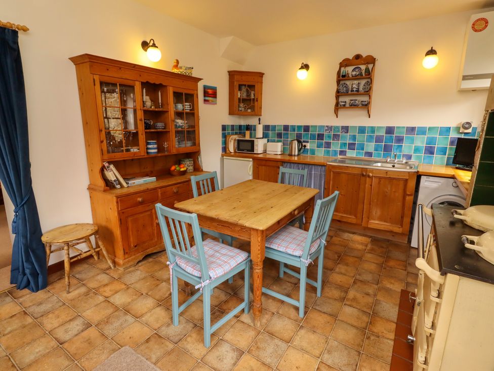 A kitchen with wooden furniture and appliances at Lavender Cottage (Bailiffgate) Alnwick
