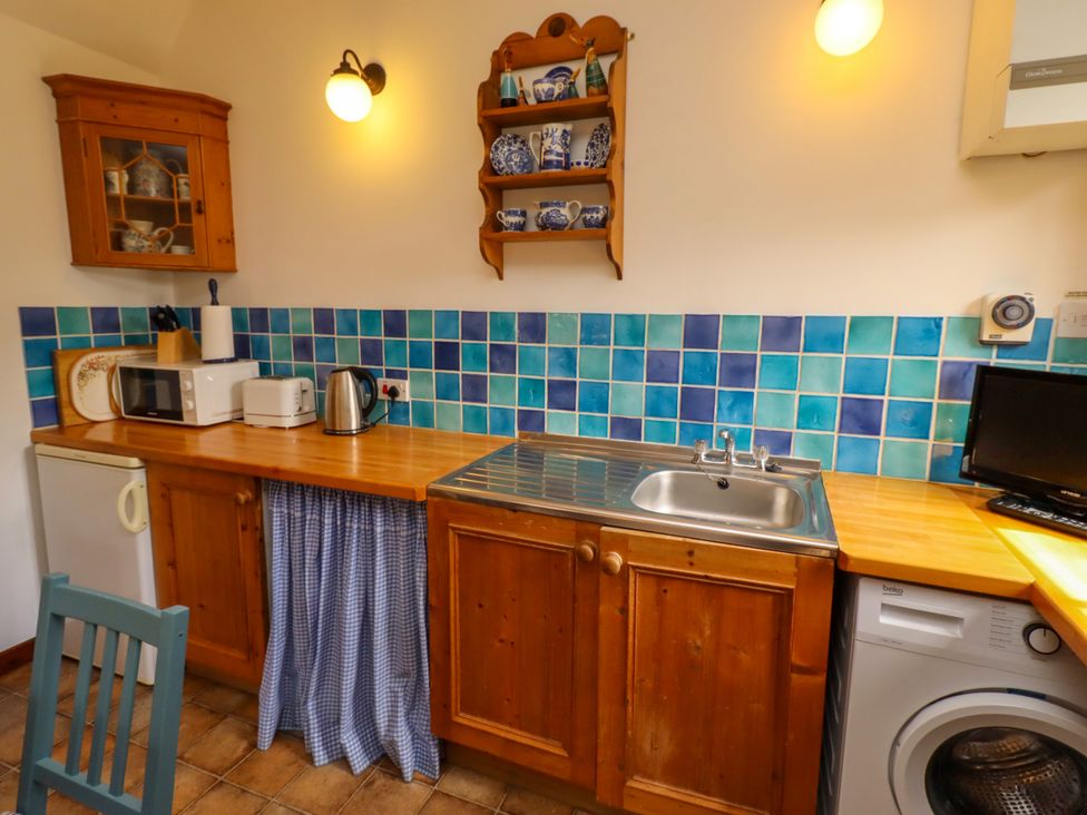 A kitchen with a sink and appliances at Lavender Cottage (Bailiffgate) Alnwick