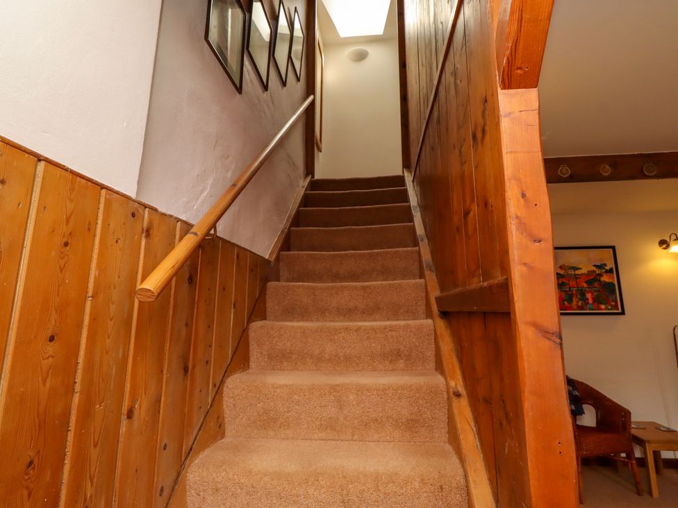 A staircase with carpet and framed pictures at Lavender Cottage (Bailiffgate) Alnwick