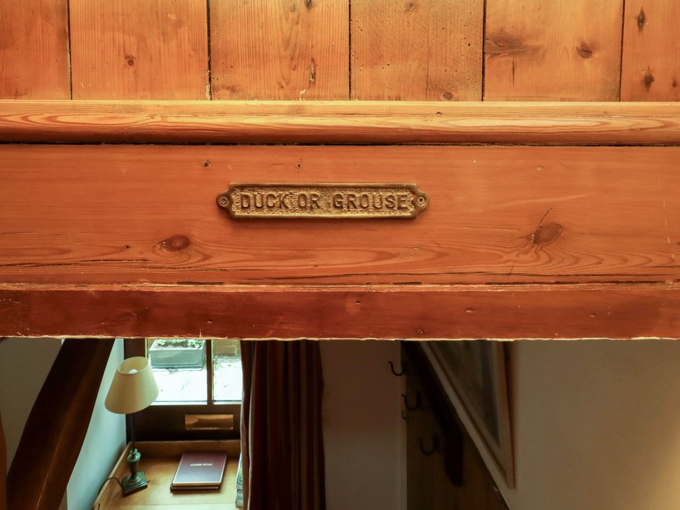 A wooden sign labeled Duck or Grouse in a hallway at Lavender Cottage (Bailiffgate) in Alnwick