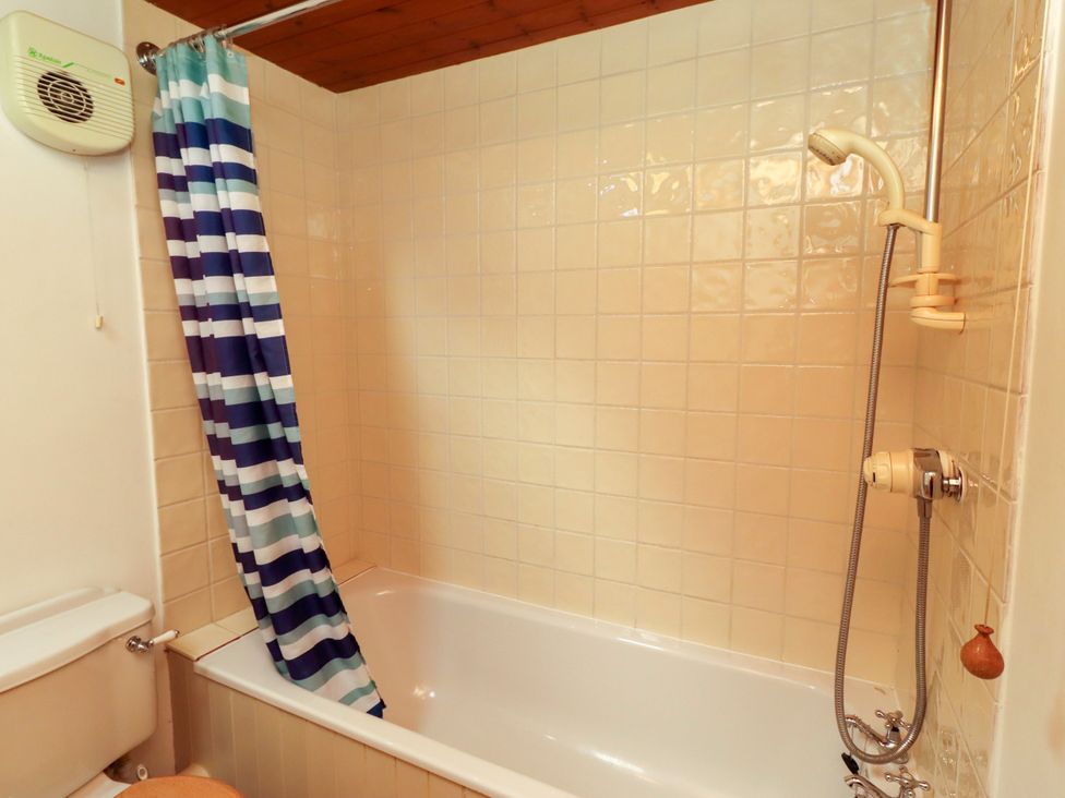 A bathroom with a bathtub and shower at Lavender Cottage (Bailiffgate) Alnwick