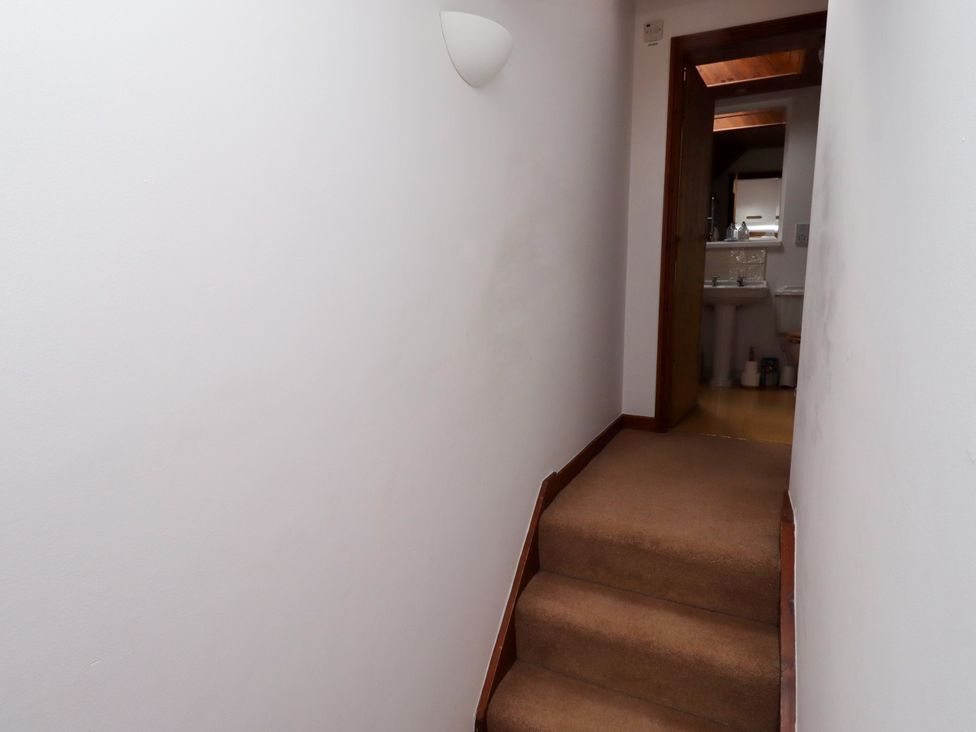A hallway with stairs leading to a bathroom at Lavender Cottage (Bailiffgate) Alnwick