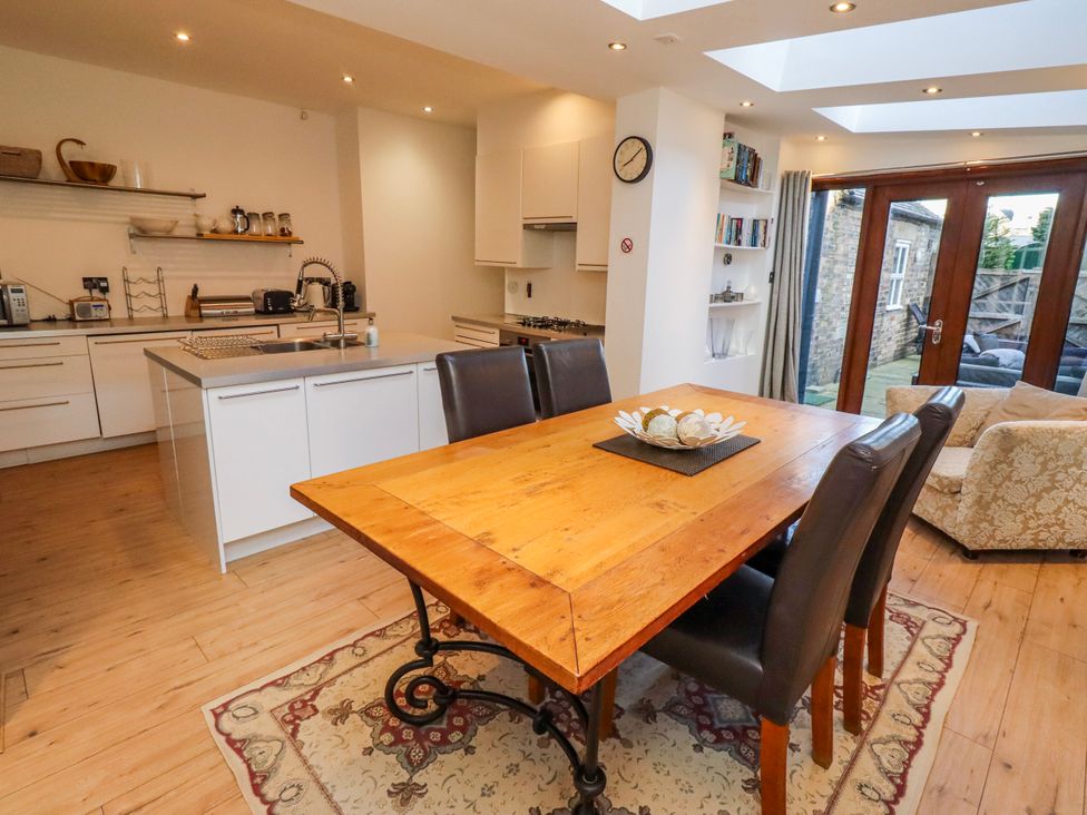 A kitchen with a wooden dining table and chairs at Alnbank in Alnmouth
