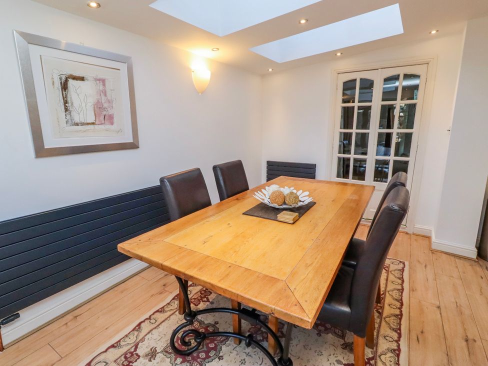 A dining room with a wooden table and chairs at Alnbank in Alnmouth