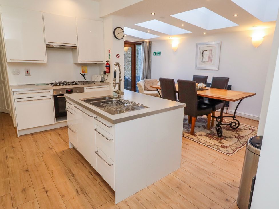 A kitchen with dining area and modern appliances at Alnbank in Alnmouth