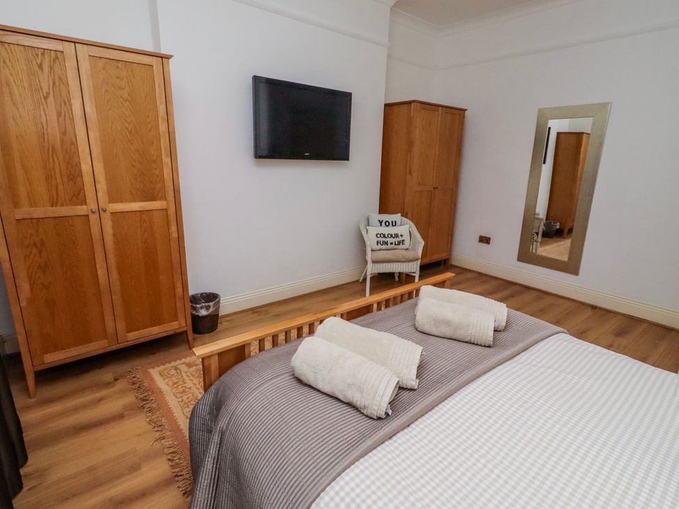 A bedroom with a bed and wardrobe at Alnbank in Alnmouth