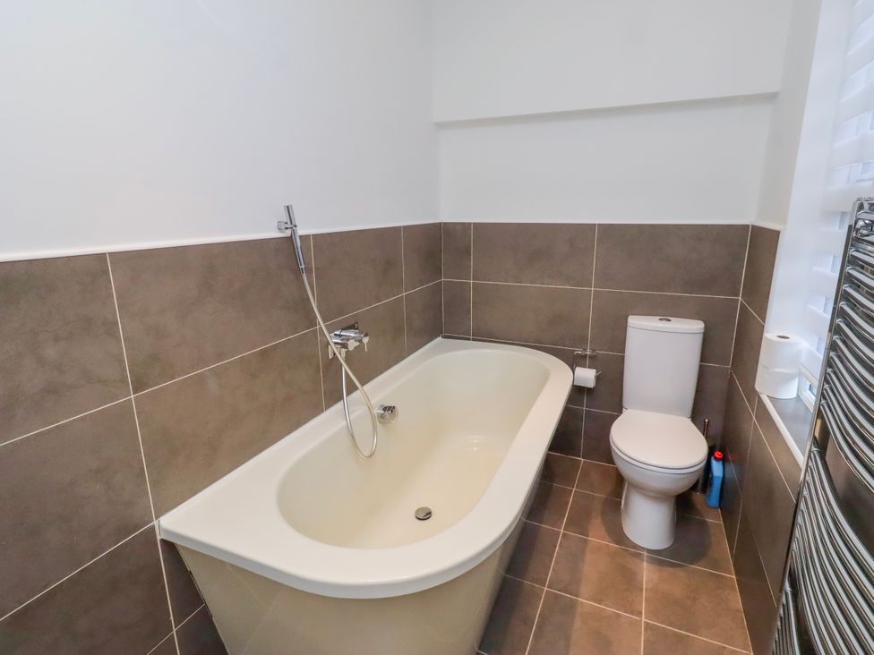 A bathroom with a bathtub and toilet at Alnbank in Alnmouth