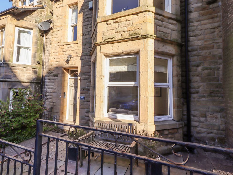 A house exterior with a bench and plants at Alnbank in Alnmouth