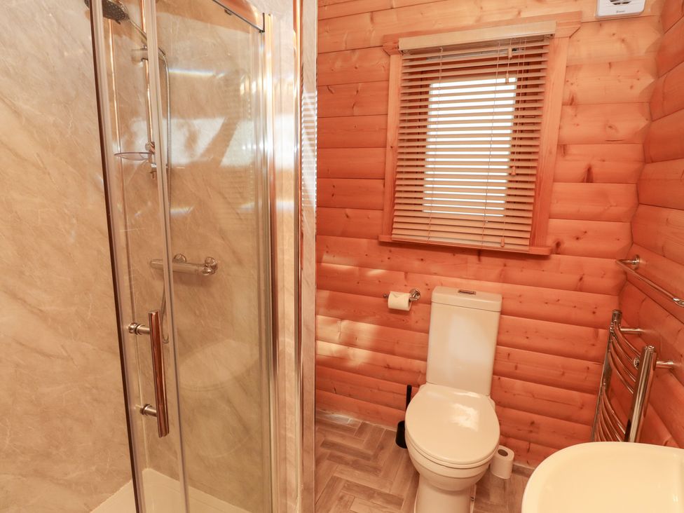 A bathroom with a shower and toilet at Heather Cottages - Brown Owl in Bamburgh