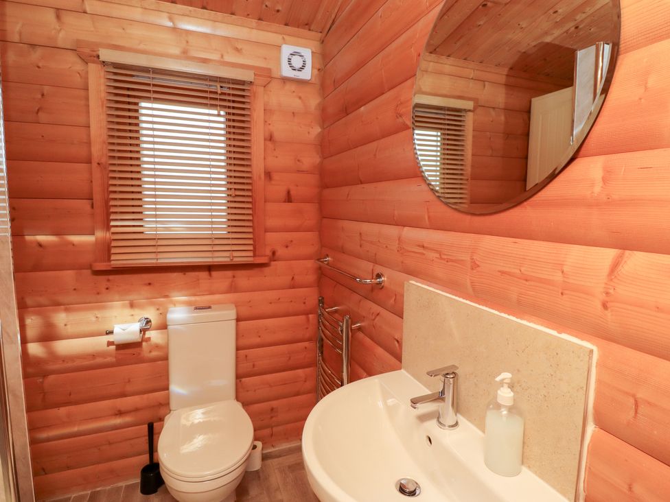 A bathroom with a toilet and sink at Heather Cottages - Brown Owl in Bamburgh