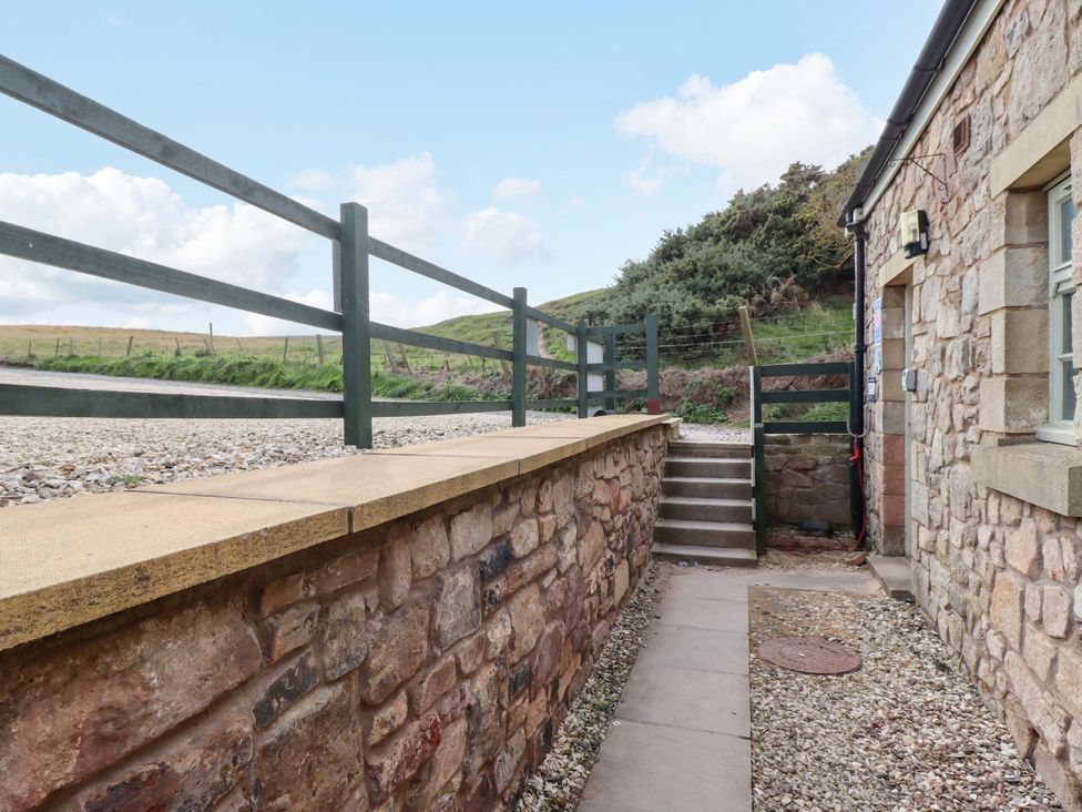 An outdoor path with steps leading to a cottage at Heather Cottages - Grayling in Bamburgh