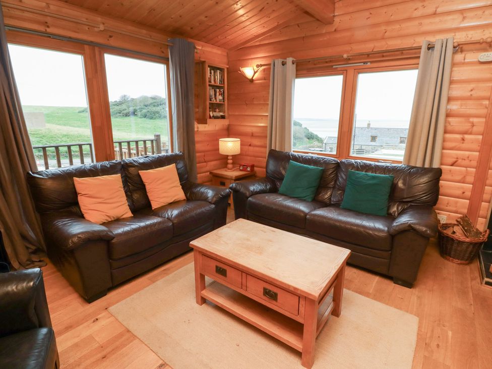A living room with sofas and a coffee table at Heather Cottages - Grey Heron in Bamburgh