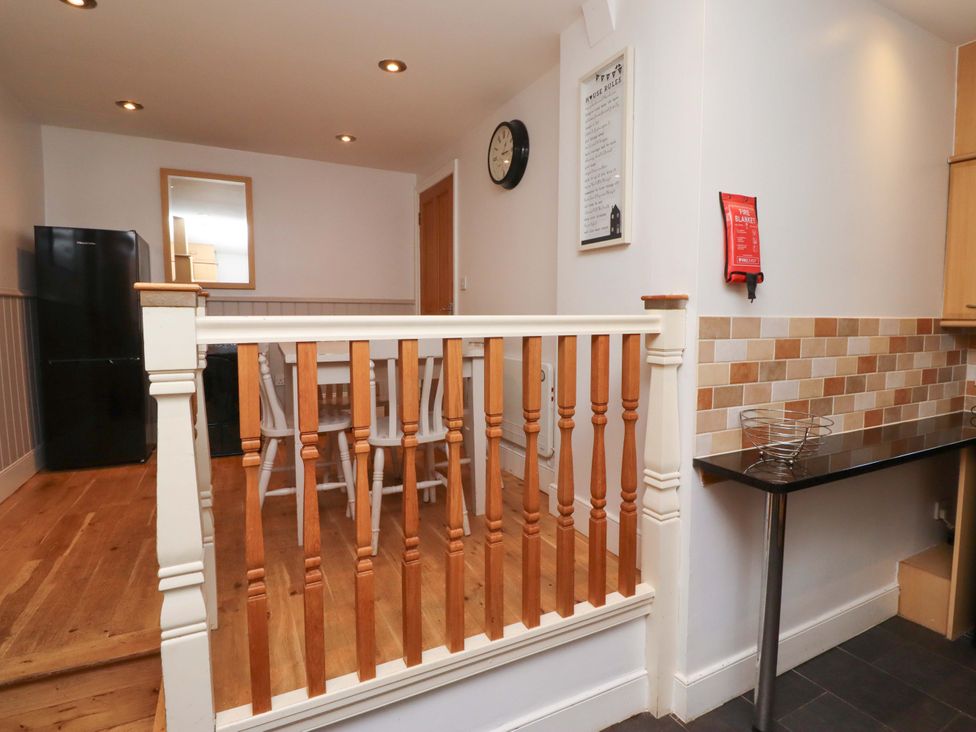 A kitchen with a dining table and chairs at Heather Cottages - Grey Seal in Bamburgh