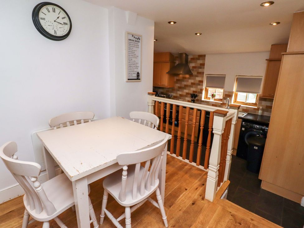 A kitchen with a table and chairs at Heather Cottages - Grey Seal in Bamburgh
