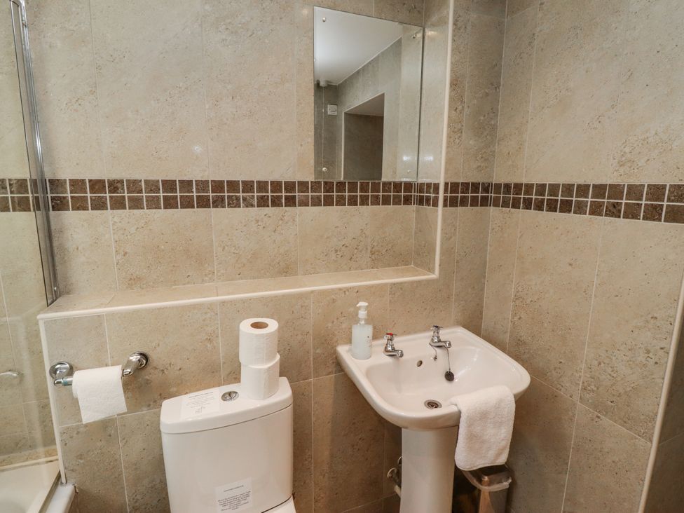 A bathroom with a toilet and hand basin at Heather Cottages - Plover in Bamburgh