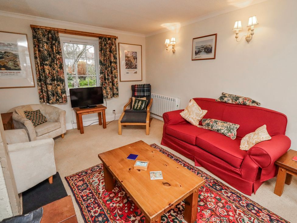 A living room with a sofa and television at St Marys Cottages No4 Low Newton-by-the-Sea