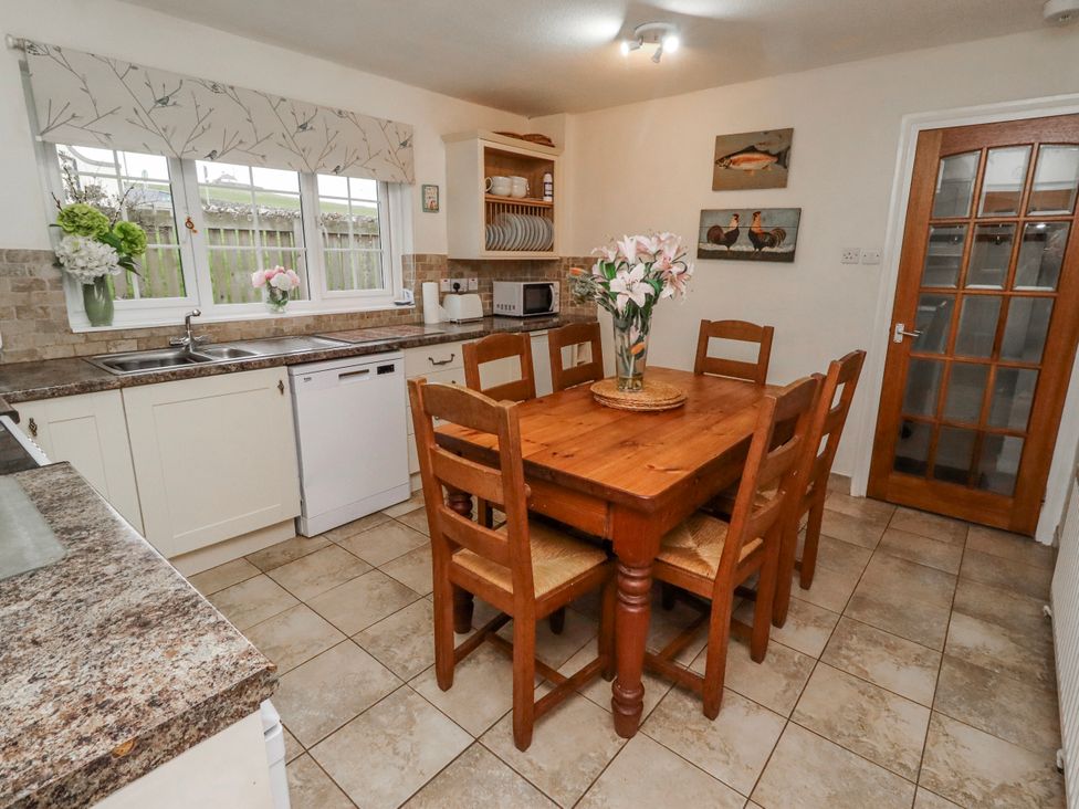 A kitchen with a table and chairs at St Marys Cottages No4 Low Newton-by-the-Sea