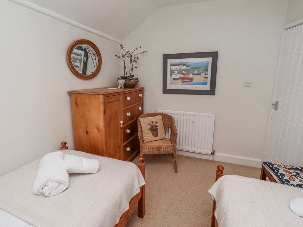 A bedroom with two beds and a dresser at St Marys Cottages No4 Low Newton-by-the-Sea