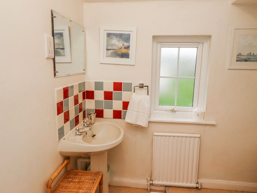 A bathroom with a sink and mirror at St Marys Cottages No4 Low Newton-by-the-Sea