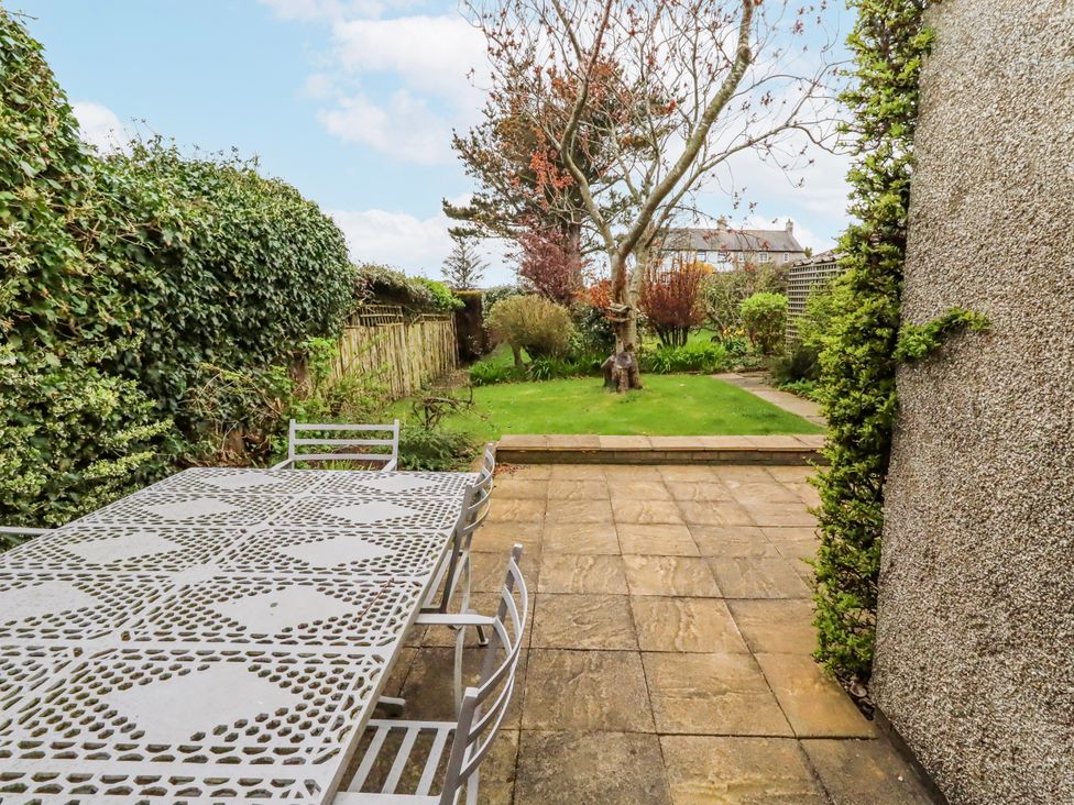 A garden with a table and chairs at St Marys Cottages No4 in Low Newton-by-the-Sea