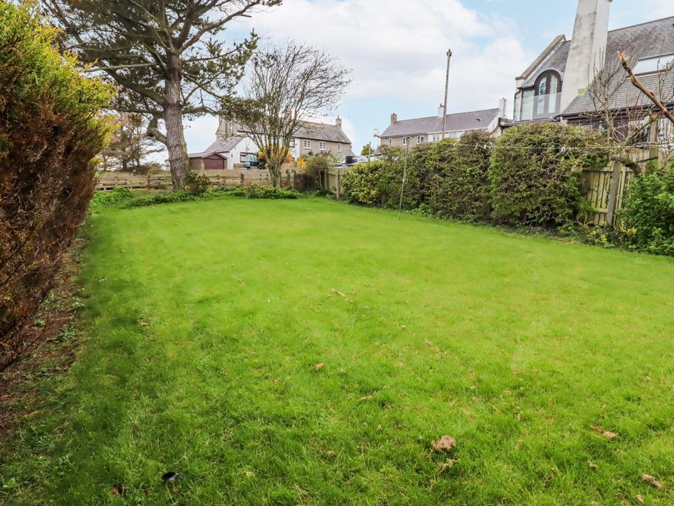 A garden with grass and trees at St Marys Cottages No4 Low Newton-by-the-Sea