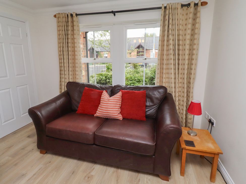 A living room with a sofa and window at Sugar Sands in Longhoughton