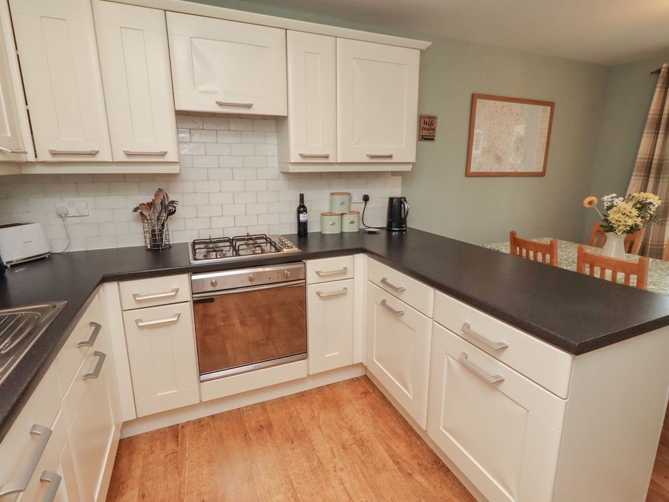 A kitchen with a stove and sink at Sugar Sands in Longhoughton