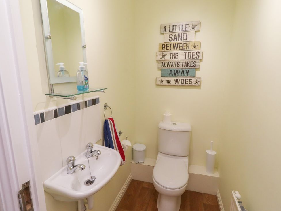 A bathroom with a toilet and sink at Sugar Sands in Longhoughton