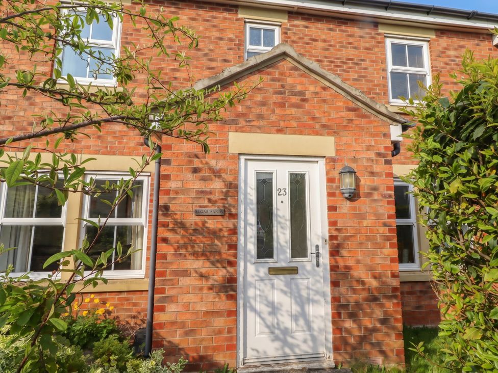 Front view of a house with a door and windows at Sugar Sands in Longhoughton