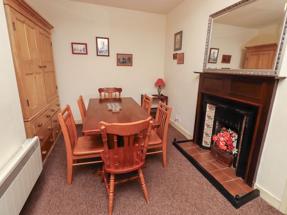 A dining room with a table and chairs at Wayside Cottage in Newton-by-the-Sea