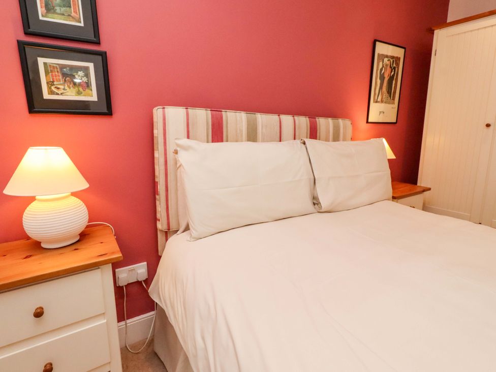 A bedroom with a bed and bedside tables at Wynding Down in Bamburgh