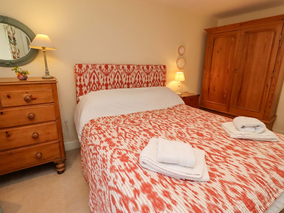 A bedroom with a bed and furniture at Wynding Down in Bamburgh