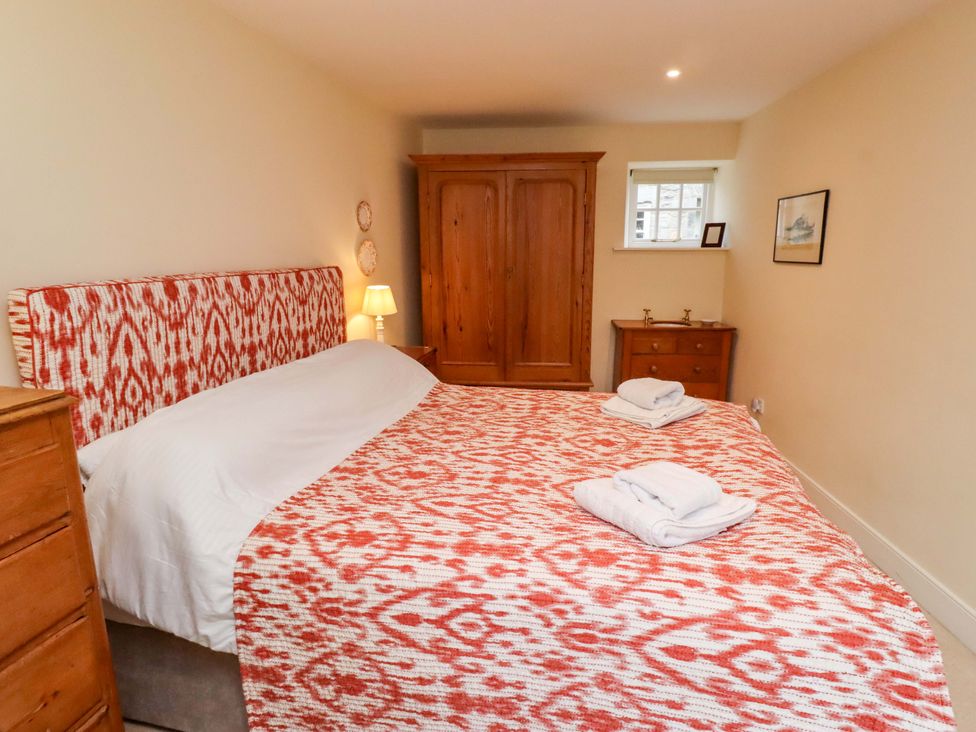 A bedroom with a bed and wardrobe at Wynding Down in Bamburgh