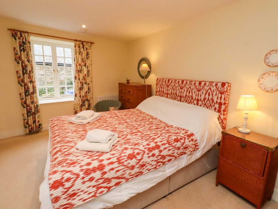 A bedroom with a bed and bedside table at Wynding Down in Bamburgh
