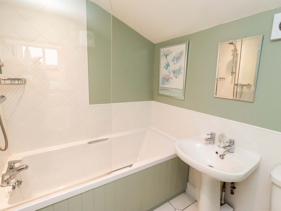 A bathroom with bathtub and sink at Wynding Down in Bamburgh