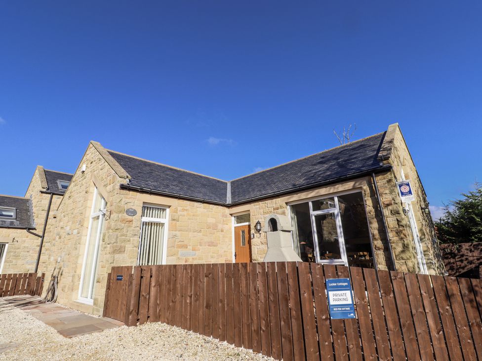 A house with a fence and sign at Red Fox in Lucker