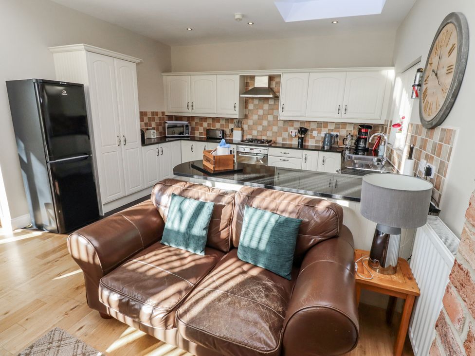 A kitchen with a sofa and various appliances at Red Fox in Lucker