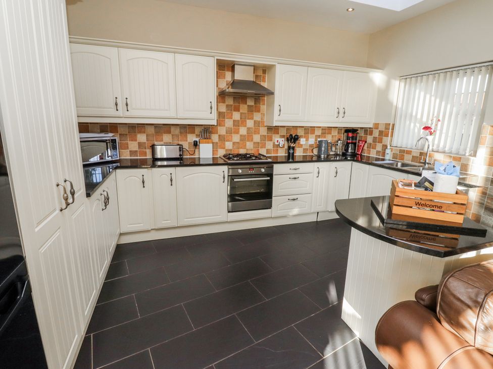 A kitchen with cabinets, appliances and a countertop at Red Fox in Lucker