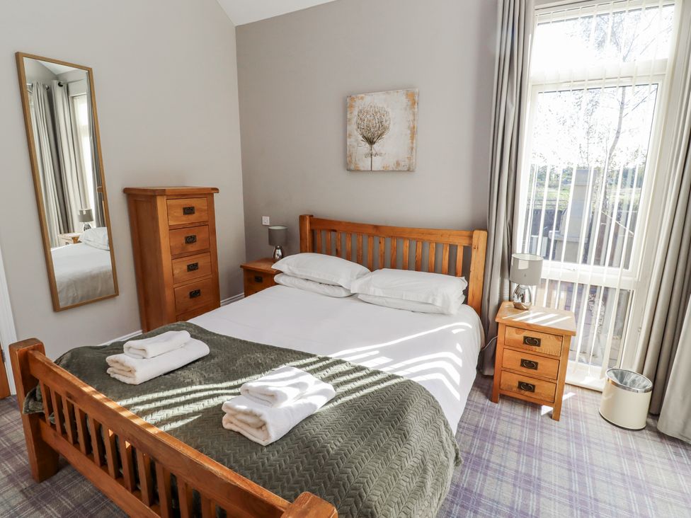 A bedroom with a bed and nightstand at Red Fox in Lucker