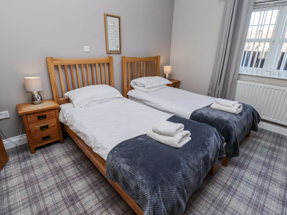 A bedroom with two beds and a nightstand at Red Fox in Lucker