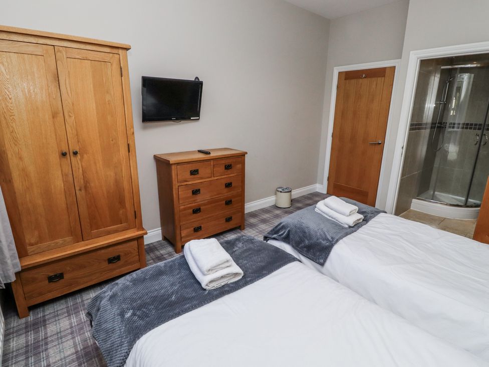 A bedroom with a wardrobe and chest of drawers at Red Fox in Lucker
