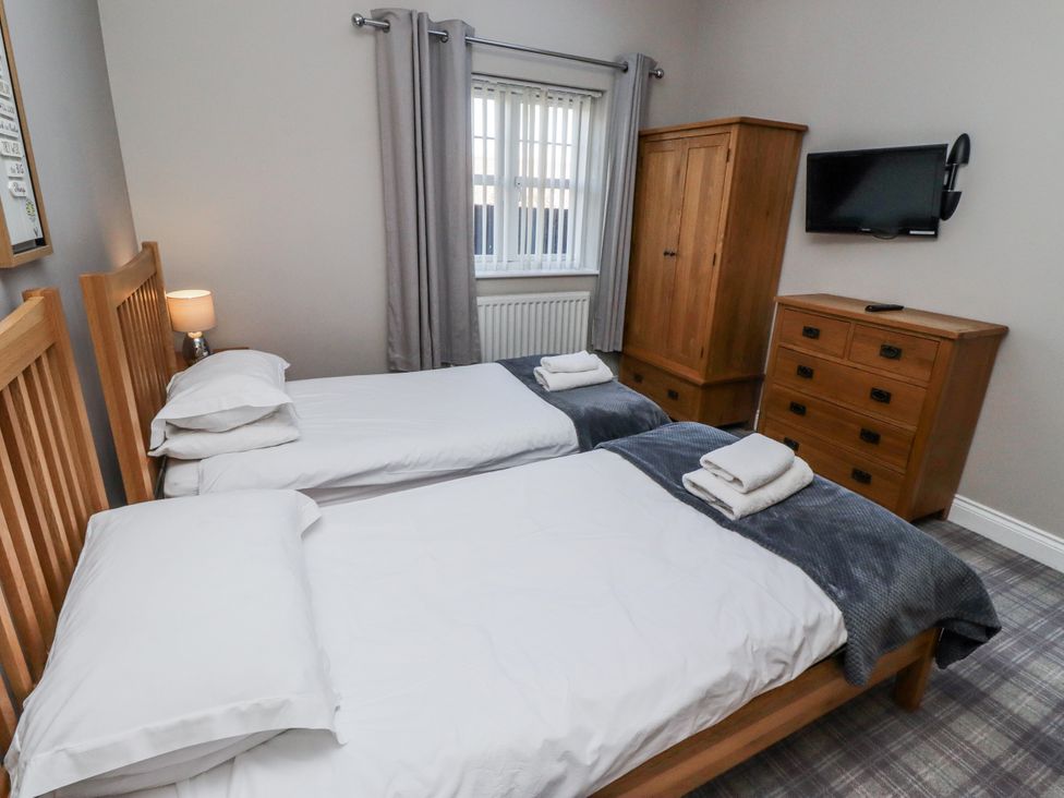 A bedroom with two beds and a wardrobe at Red Fox in Lucker