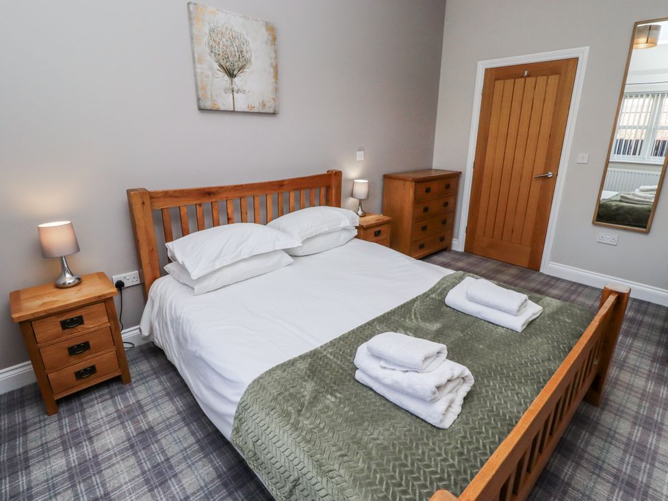 A bedroom with a bed and nightstands at Red Fox in Lucker